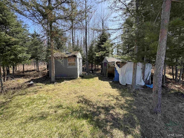 5278 27.5 Rd, Gladstone, MI 49837 - view of green lawn featuring a storage shed and an outbuilding
