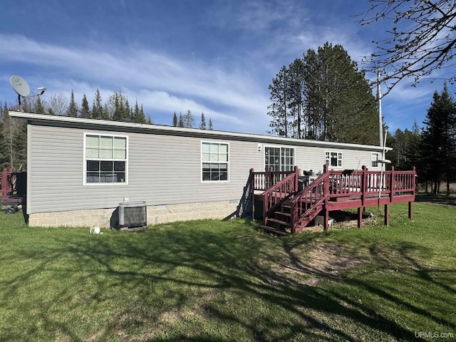 5278 27.5 Rd, Gladstone, MI 49837 - back of property featuring a deck, a yard, and central air condition unit