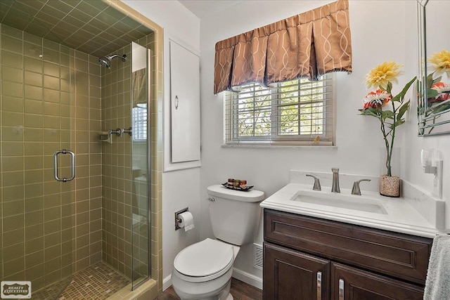 full bathroom with a shower stall, toilet, and vanity