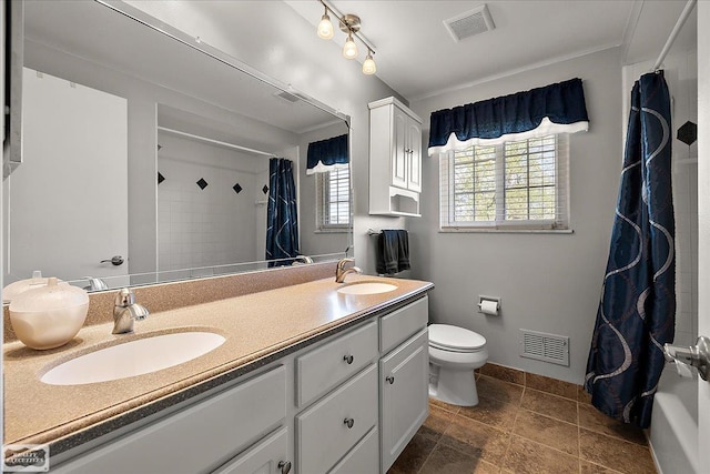 bathroom featuring toilet, double vanity, shower / bath combination with curtain, and baseboards