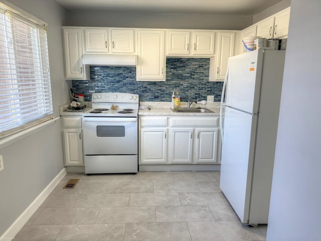 kitchen featuring white appliances, a sink, under cabinet range hood, decorative backsplash, and white cabinetry