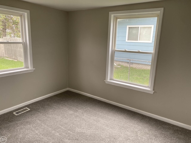 carpeted empty room with baseboards