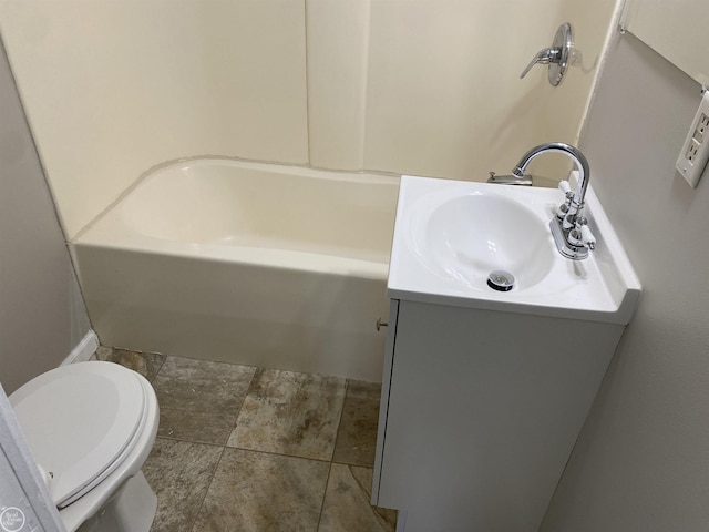 full bathroom featuring vanity, a bath, and toilet