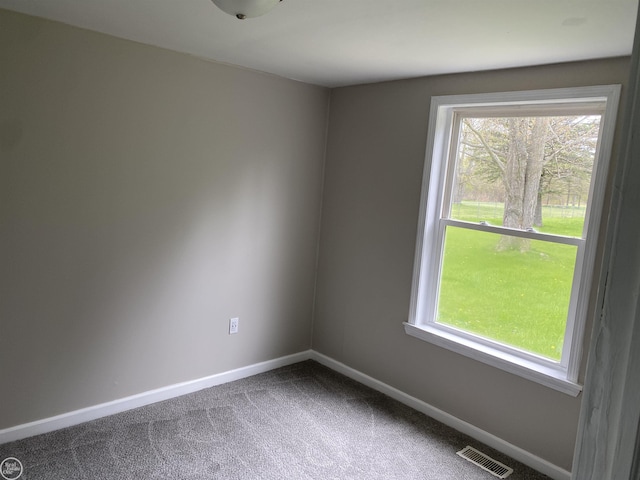 empty room with carpet and baseboards