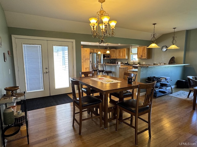 6403 N 1st St, Wells, MI 49894 - dining space with french doors, dark wood-style floors, vaulted ceiling, and healthy amount of natural light