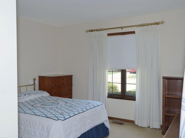bedroom with carpet and baseboards