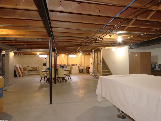 basement featuring washer and dryer, a sink, and stairway