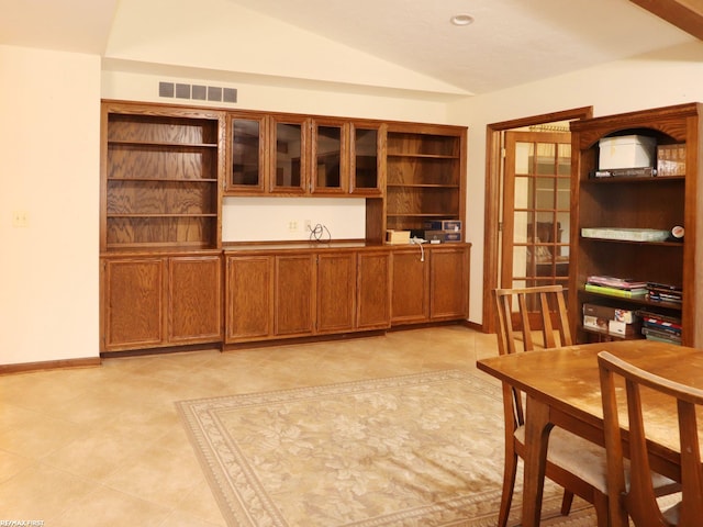office area featuring vaulted ceiling and baseboards