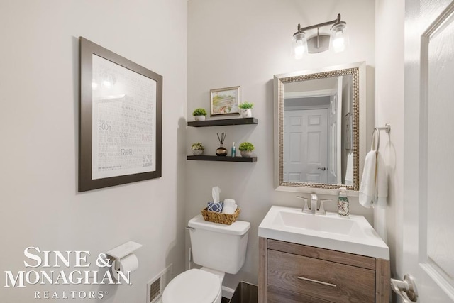 bathroom featuring toilet and vanity