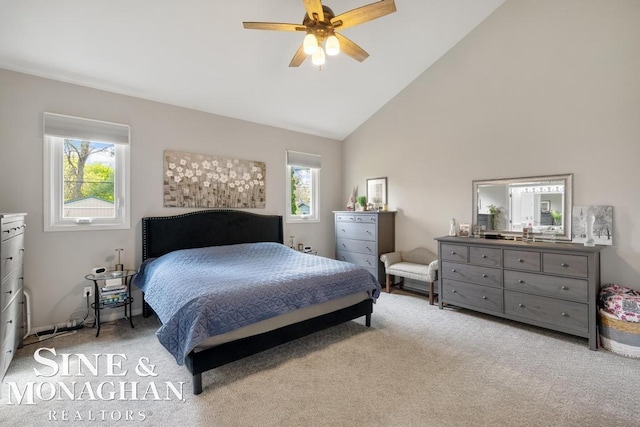 bedroom featuring multiple windows, light carpet, high vaulted ceiling, and a ceiling fan