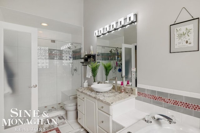 full bath with a stall shower, vanity, toilet, and a garden tub