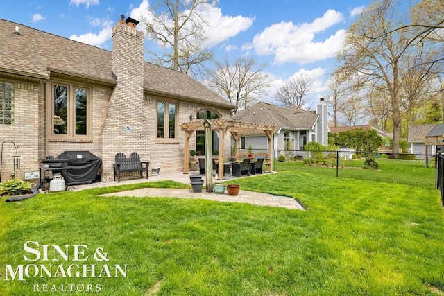 back of property featuring a pergola, brick siding, a shingled roof, a patio area, and a chimney