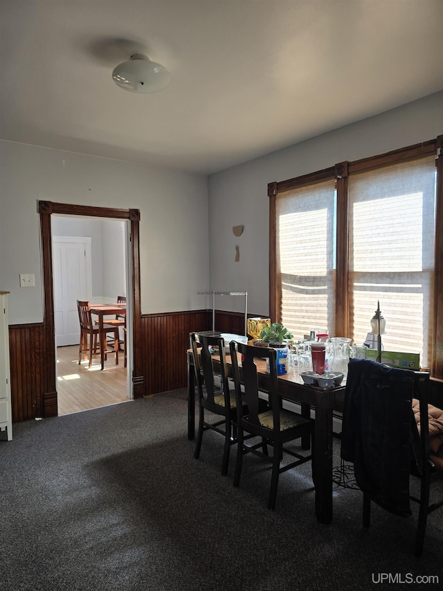 118 S Tamarack St, Laurium, MI 49913 - dining space with a wainscoted wall, carpet, and wooden walls