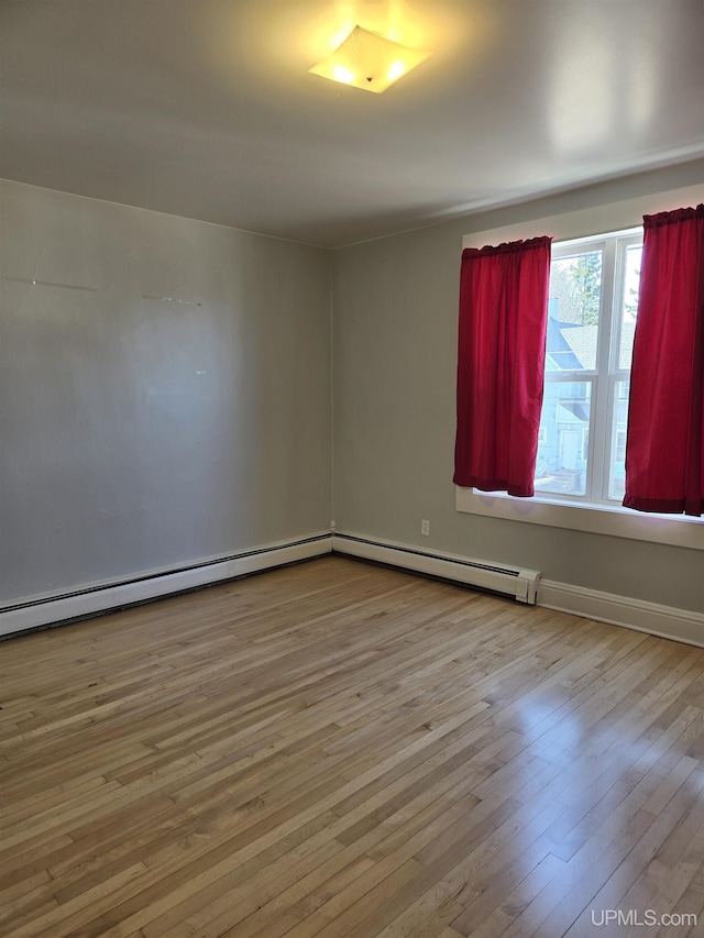 118 S Tamarack St, Laurium, MI 49913 - unfurnished room with hardwood / wood-style floors, a baseboard heating unit, and baseboards