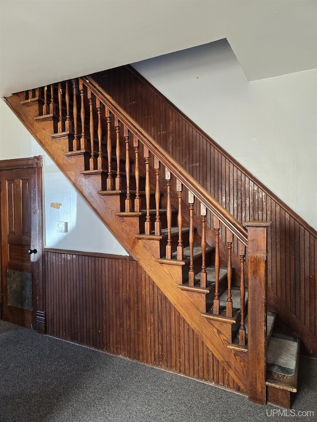 118 S Tamarack St, Laurium, MI 49913 - staircase featuring carpet flooring and wood walls