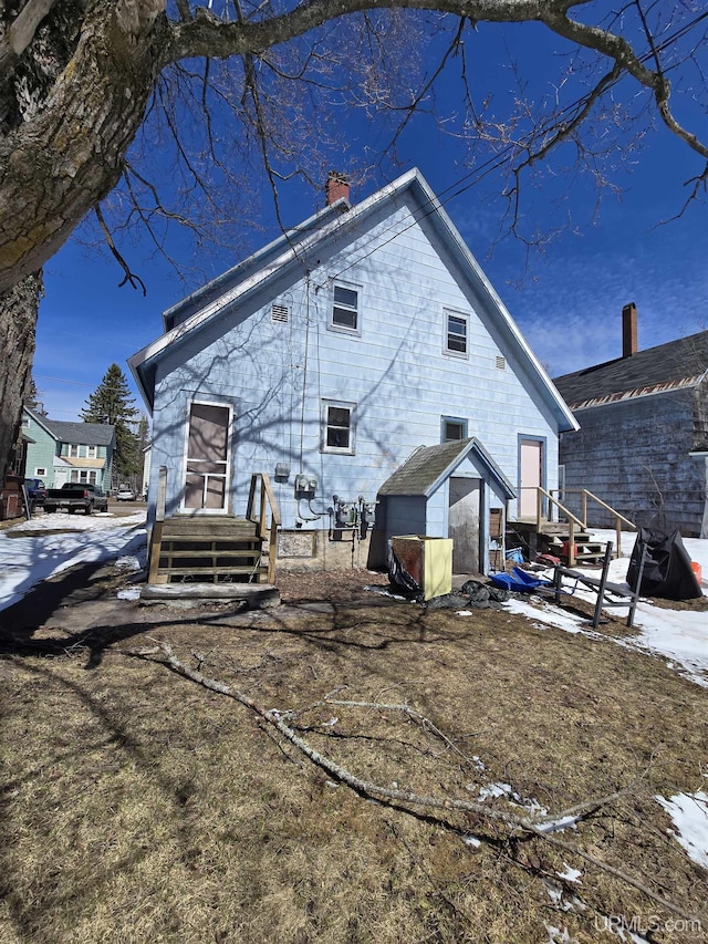 118 S Tamarack St, Laurium, MI 49913 - rear view of property with a chimney, an outbuilding, and a storage shed