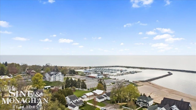 aerial view of property and surrounding area with a nearby body of water