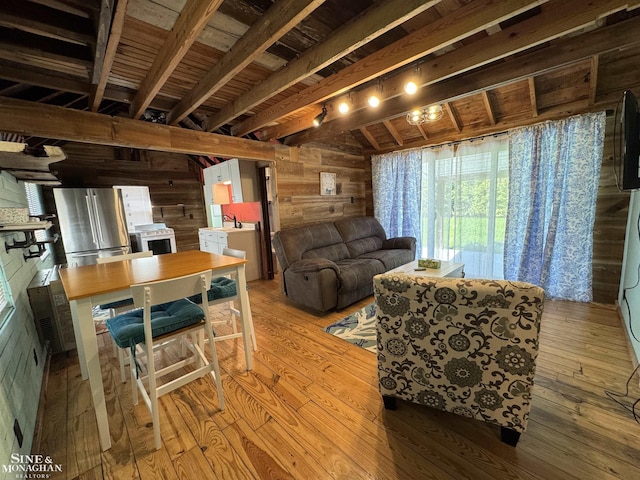living room with wood walls and hardwood / wood-style flooring