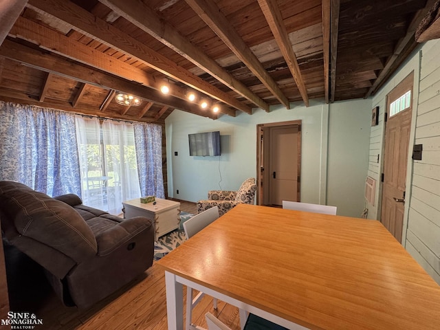 dining space with wood ceiling, beam ceiling, and light wood finished floors