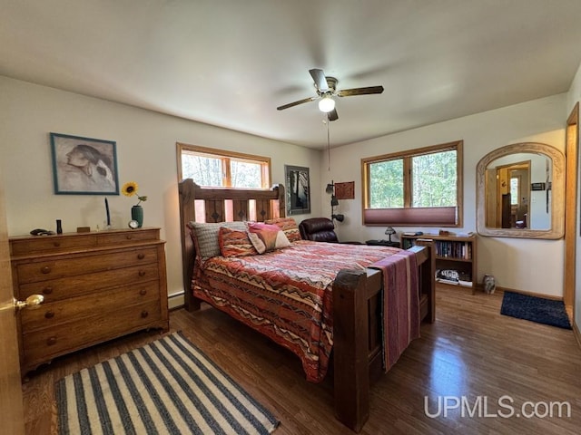 698 E River Dr, Lanse, MI 49946 - bedroom featuring multiple windows, wood finished floors, baseboards, and a ceiling fan