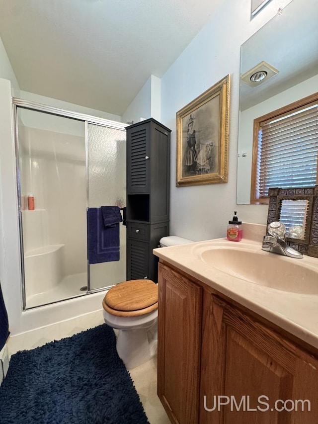 698 E River Dr, Lanse, MI 49946 - full bath with toilet, a stall shower, vanity, and tile patterned floors