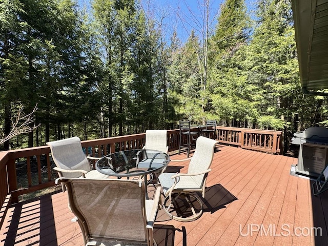 698 E River Dr, Lanse, MI 49946 - wooden terrace featuring outdoor dining area and area for grilling