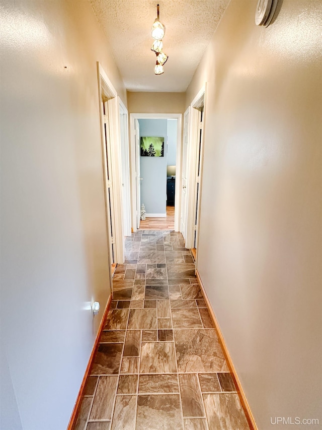2246 Allen St, Marquette, MI 49855 - hallway featuring baseboards and a textured ceiling
