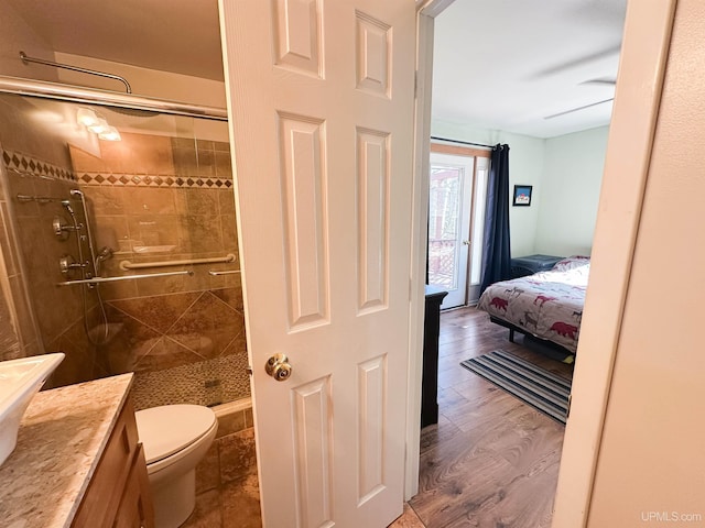 2246 Allen St, Marquette, MI 49855 - bathroom featuring a shower stall, toilet, vanity, and wood finished floors