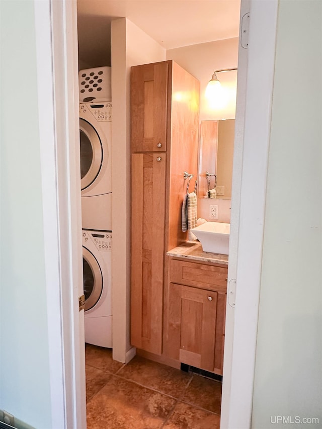 2246 Allen St, Marquette, MI 49855 - bathroom with stacked washer and clothes dryer, vanity, and tile patterned floors