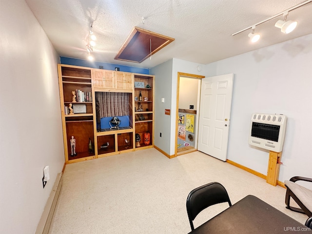 2246 Allen St, Marquette, MI 49855 - living room featuring heating unit, track lighting, attic access, baseboards, and a textured ceiling