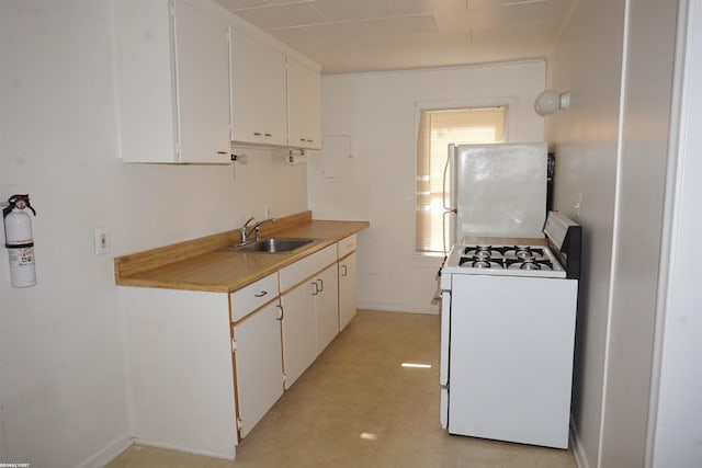 26333 Belanger St, Roseville, MI 48066 - kitchen with white appliances, a sink, light countertops, and white cabinets