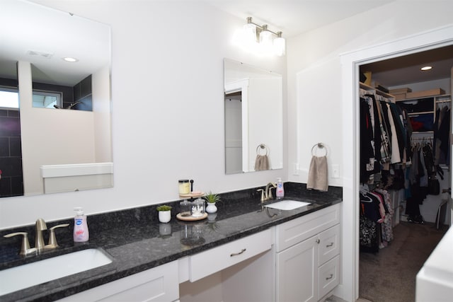 7272 S 7 Mile Rd, Freeland, MI 48623 - bathroom with a walk in closet and double vanity