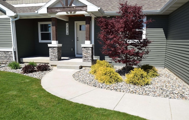 7272 S 7 Mile Rd, Freeland, MI 48623 - doorway to property with roof with shingles, a porch, and stone siding