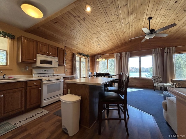 3260 Herron Dr, Gwinn, MI 49841 - kitchen with white appliances, a sink, light countertops, lofted ceiling, and healthy amount of natural light