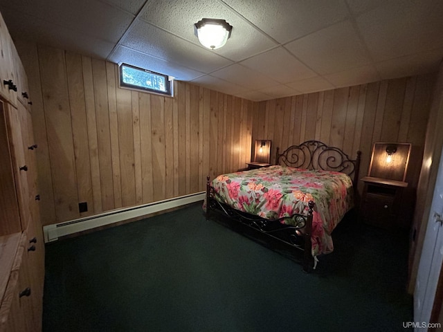 3260 Herron Dr, Gwinn, MI 49841 - bedroom featuring a baseboard radiator, a drop ceiling, wood walls, and carpet flooring