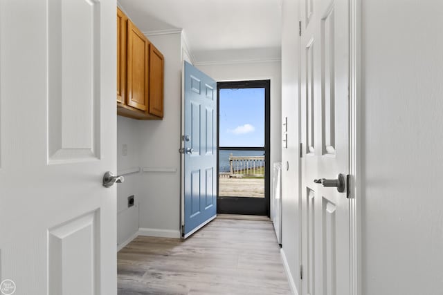 doorway featuring light wood-style flooring and baseboards