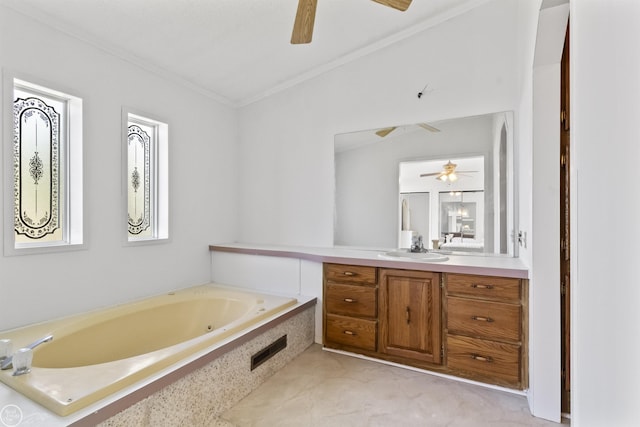 bathroom with a ceiling fan, ornamental molding, vanity, and a garden tub