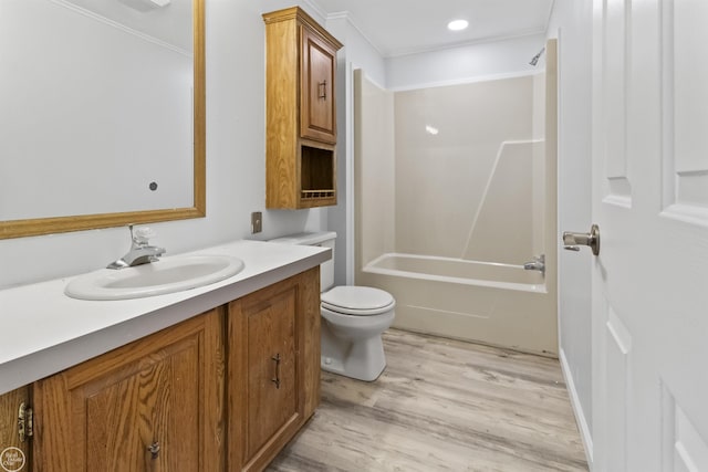 full bathroom with wood finished floors, toilet, vanity, and ornamental molding