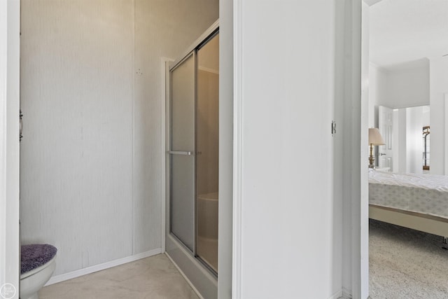 full bath featuring a shower stall, toilet, and baseboards