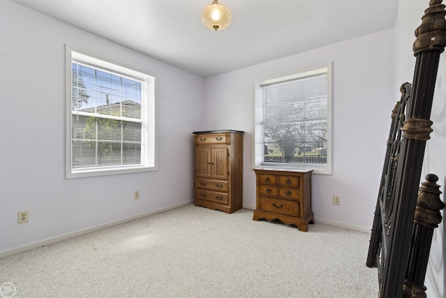 bedroom featuring carpet floors and baseboards