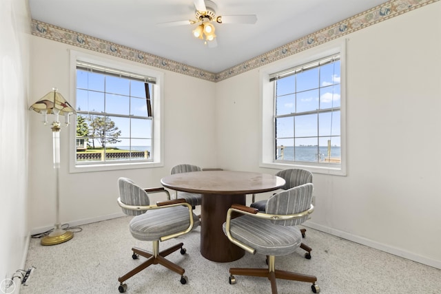 dining room with baseboards and ceiling fan