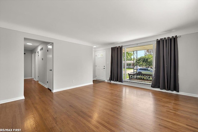 empty room with wood finished floors and baseboards