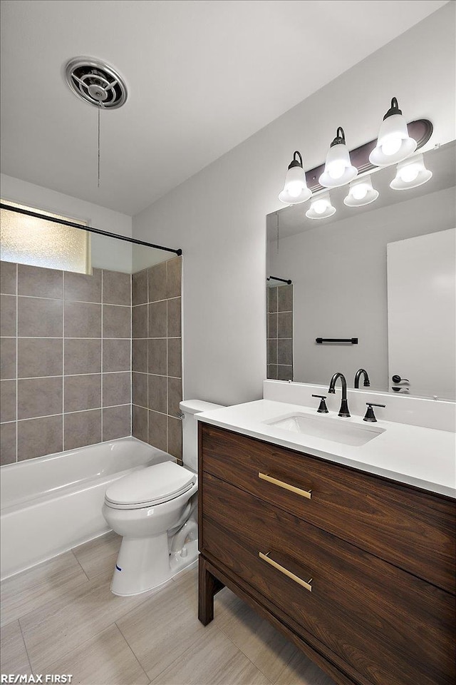 full bath with toilet, vanity, and washtub / shower combination