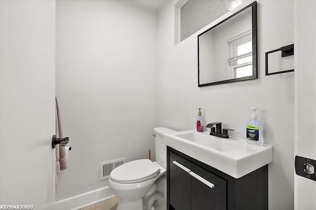 half bathroom with toilet and vanity