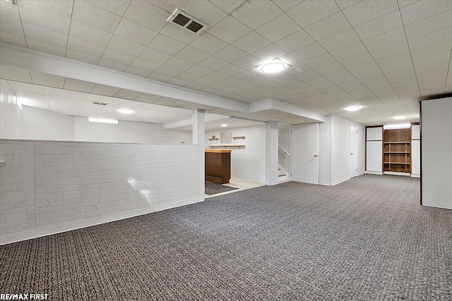 finished below grade area featuring carpet and stairway