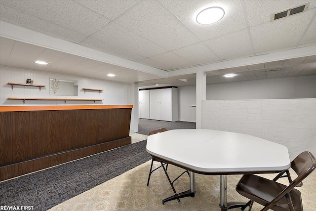 dining room featuring carpet, bar with sink, and recessed lighting