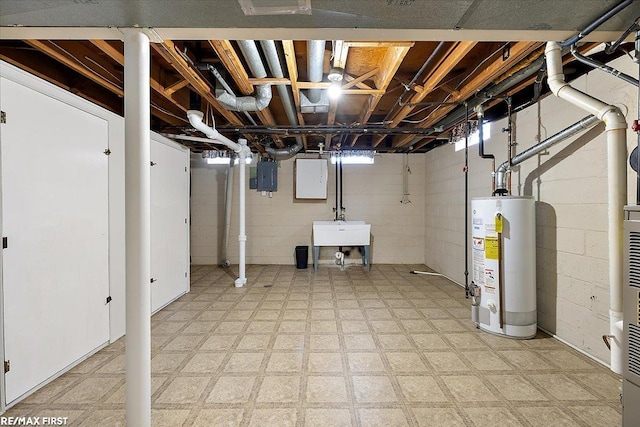 below grade area featuring gas water heater, electric panel, light floors, and a sink