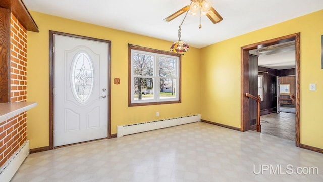 606 S 13th St, Gladstone, MI 49837 - foyer entrance featuring a baseboard heating unit, light flooring, and baseboards