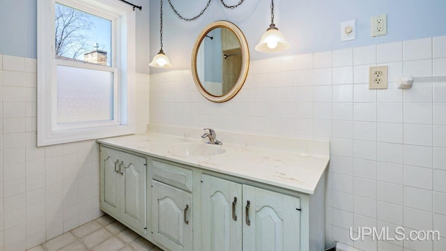 606 S 13th St, Gladstone, MI 49837 - full bath with tile walls, vanity, and tile patterned floors