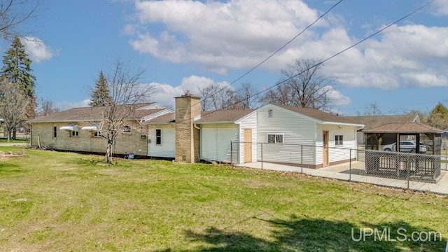 606 S 13th St, Gladstone, MI 49837 - rear view of house with a chimney